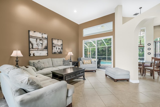 living area with a sunroom, plenty of natural light, and light tile patterned floors