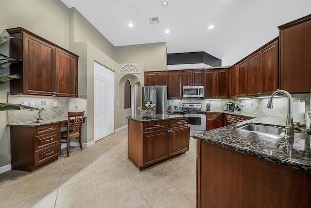 kitchen featuring light tile patterned floors, a sink, visible vents, appliances with stainless steel finishes, and dark stone countertops