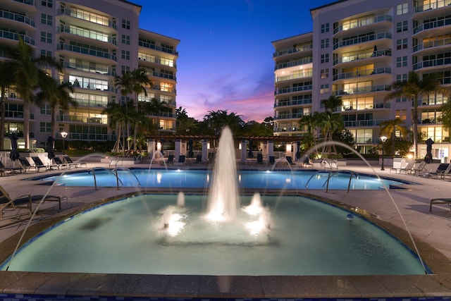 pool at dusk with pool water feature