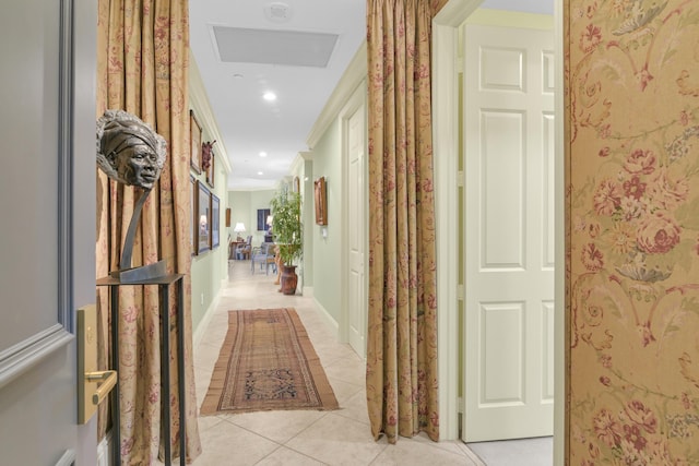 hall with light tile patterned floors and ornamental molding