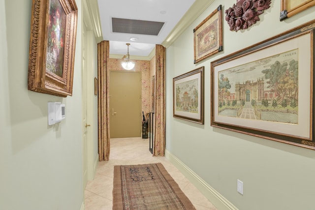 hall featuring light tile patterned flooring and ornamental molding