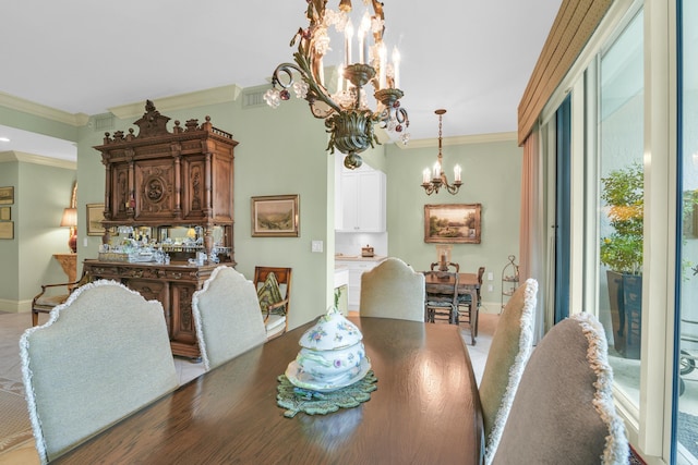 dining room with ornamental molding and an inviting chandelier