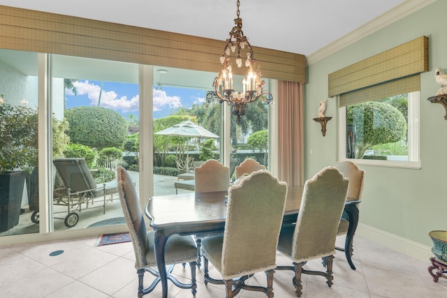 dining space featuring light tile patterned floors, crown molding, and a chandelier