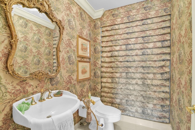 bathroom featuring tile patterned floors, toilet, sink, and crown molding