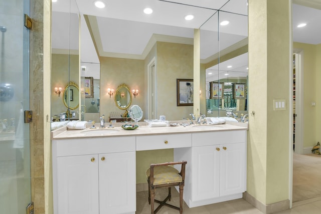 bathroom featuring tile patterned floors, vanity, a shower with door, and ornamental molding