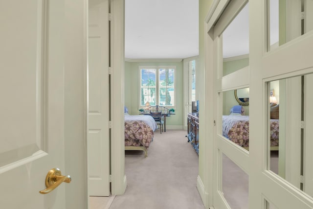 bedroom with light colored carpet and ornamental molding