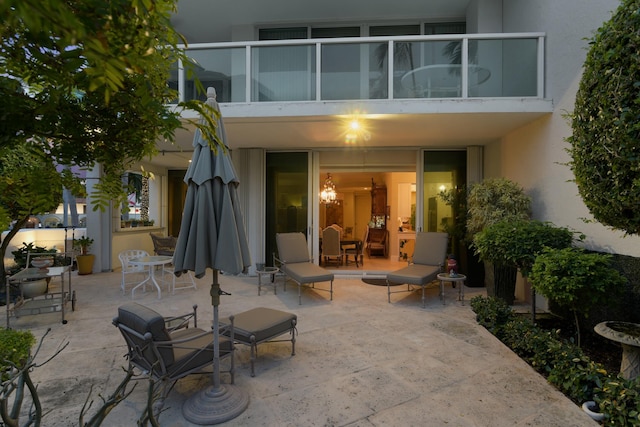 back of house with a balcony and a patio area