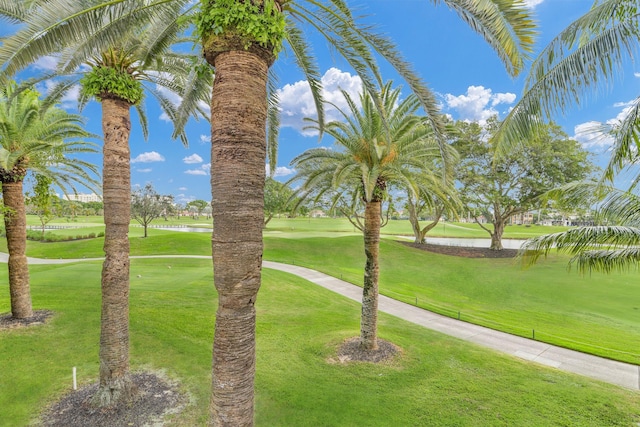 surrounding community featuring a lawn and a water view