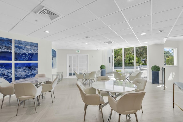 dining space featuring french doors and expansive windows