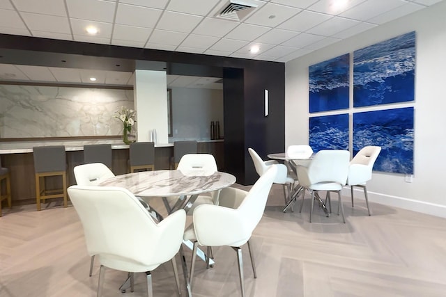 dining space featuring light parquet floors