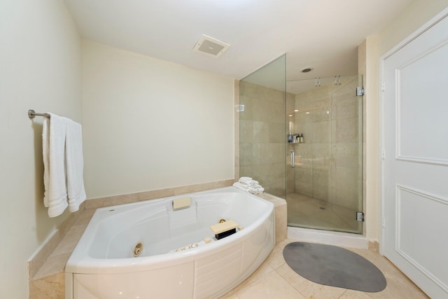 bathroom featuring tile patterned floors and independent shower and bath