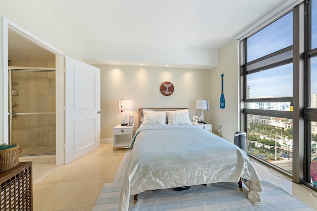 bedroom featuring multiple windows, light tile patterned flooring, and ensuite bath