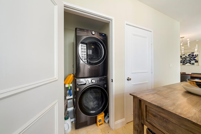 clothes washing area with stacked washer and dryer