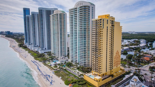 view of building exterior with a view of the beach and a water view