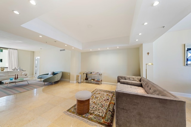 living room featuring a raised ceiling