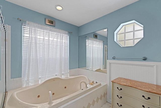 bathroom featuring tile patterned floors and a relaxing tiled tub