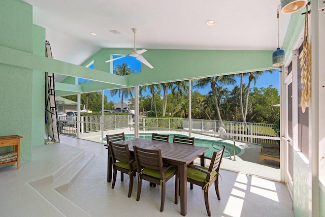 sunroom / solarium with ceiling fan and lofted ceiling