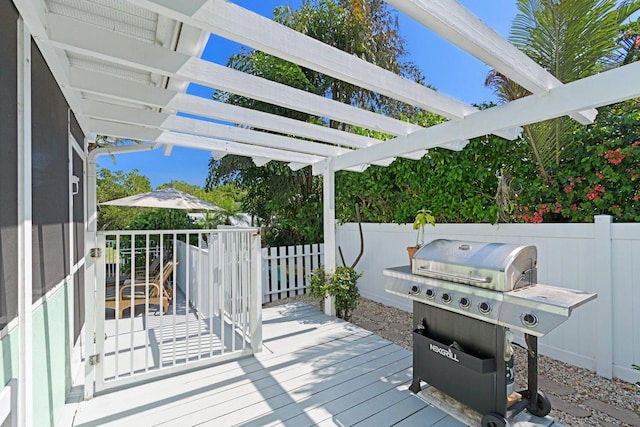 wooden deck with area for grilling and a pergola