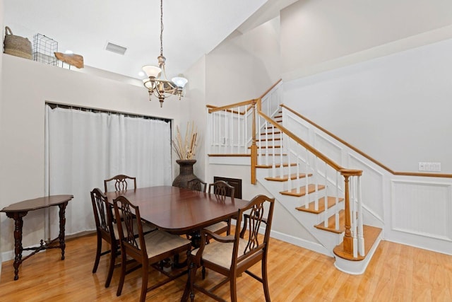 dining area featuring light hardwood / wood-style floors and a notable chandelier