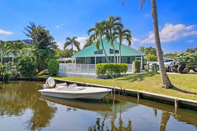 dock area featuring a lawn and a water view