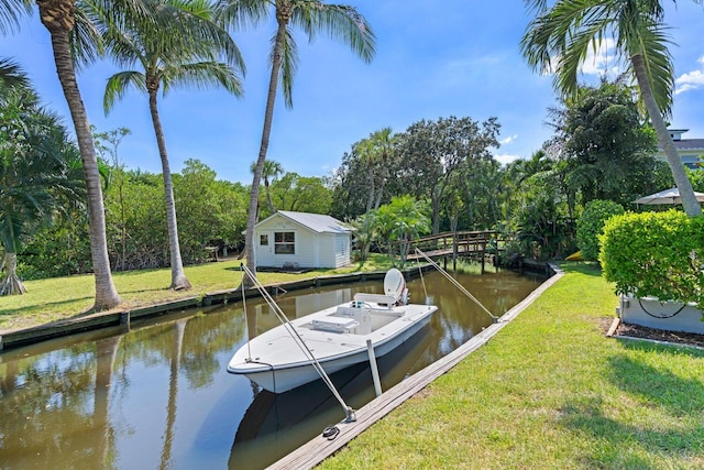 view of dock with a water view and a yard