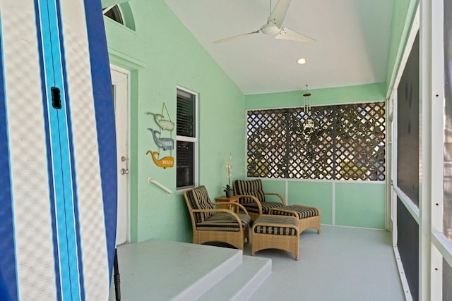 sunroom with ceiling fan and lofted ceiling