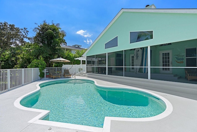 view of swimming pool with a patio and a sunroom