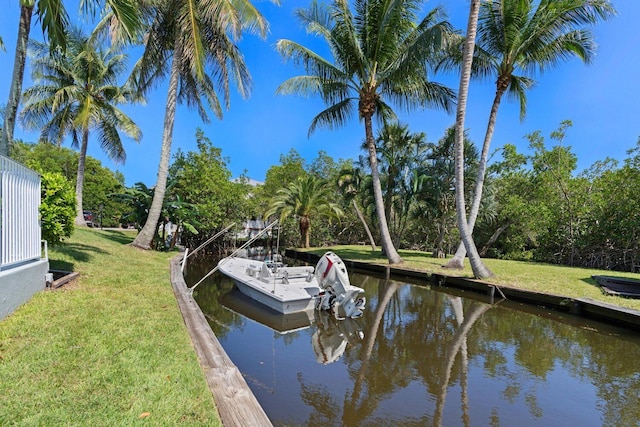 view of dock featuring a water view and a lawn