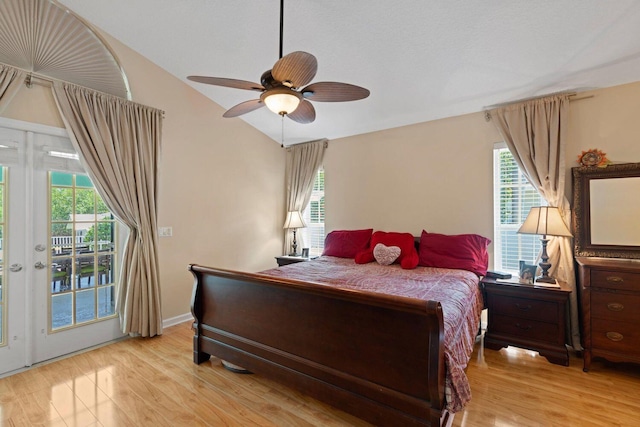 bedroom featuring access to exterior, light wood-type flooring, ceiling fan, and lofted ceiling