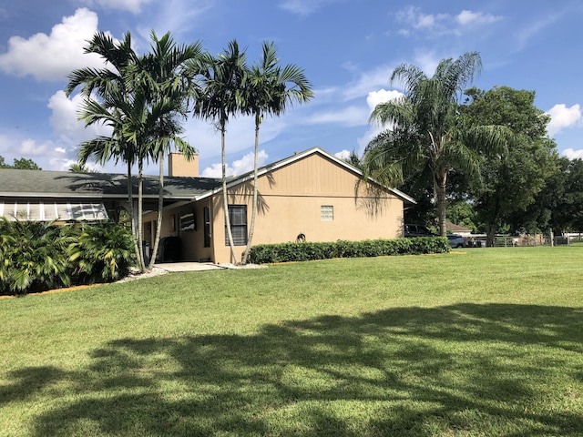 view of side of home featuring a lawn