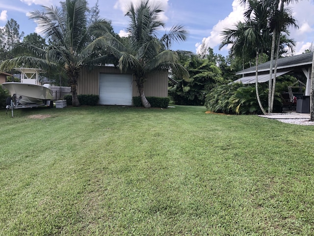 view of yard with a garage and an outdoor structure