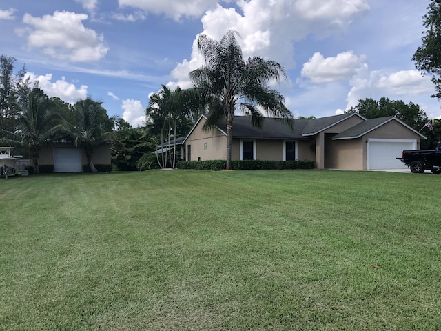 ranch-style home featuring a garage and a front lawn