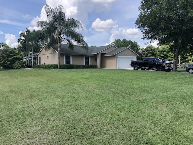 single story home with a front lawn and a garage