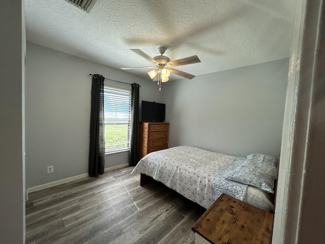 bedroom featuring a textured ceiling, hardwood / wood-style flooring, and ceiling fan