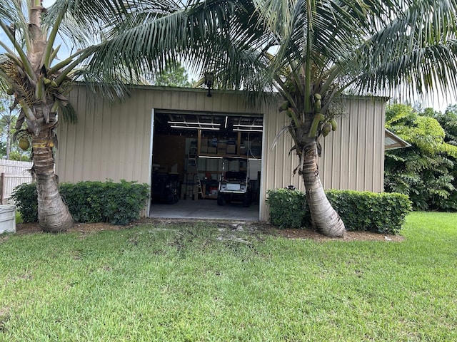 view of property exterior with a yard and an outbuilding