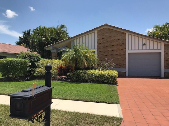 view of front of house featuring a garage and a front lawn