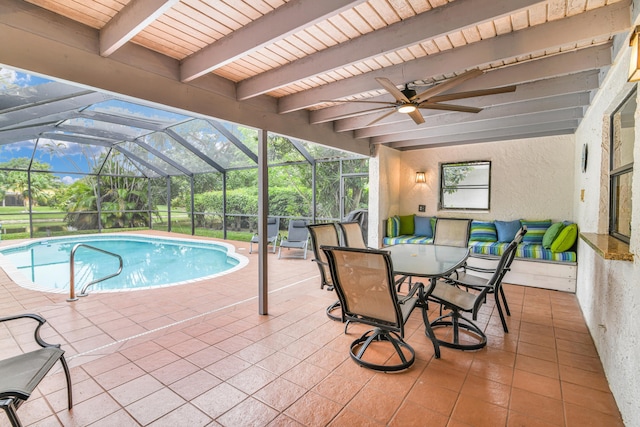 outdoor pool featuring a ceiling fan, a patio area, and glass enclosure