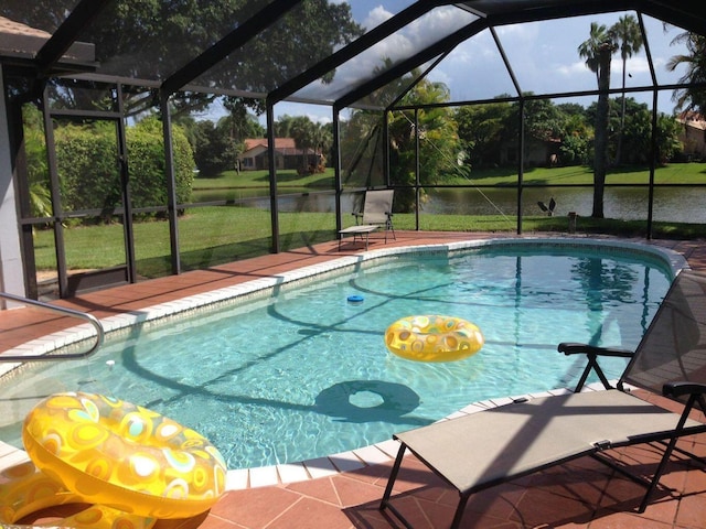 view of swimming pool with a yard, a water view, glass enclosure, and a patio area