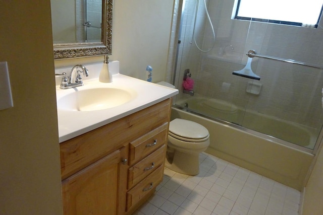 full bathroom with shower / bath combination with glass door, vanity, toilet, and tile patterned flooring