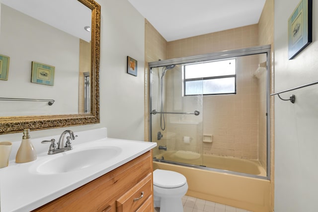 bathroom featuring enclosed tub / shower combo, vanity, and toilet