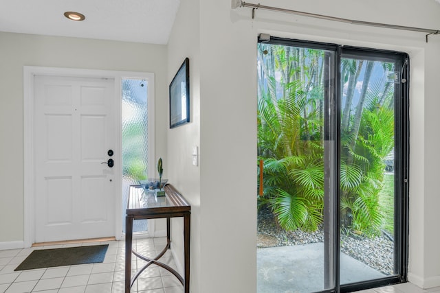 foyer entrance with recessed lighting, plenty of natural light, baseboards, and light tile patterned floors