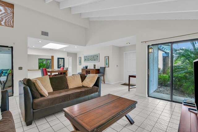 tiled living room featuring vaulted ceiling with beams