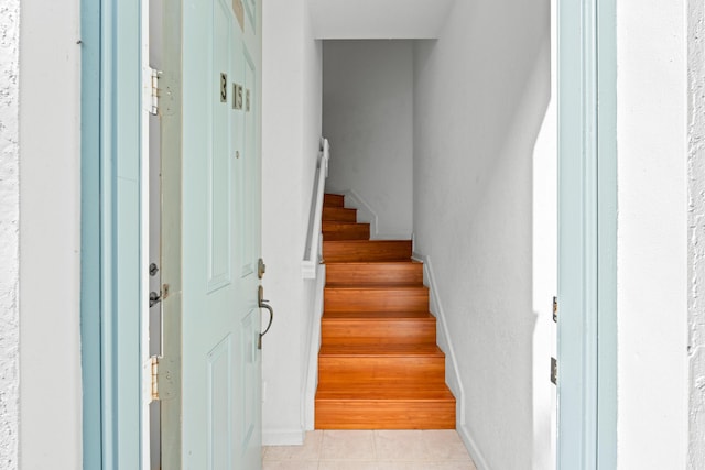 stairs with tile patterned flooring