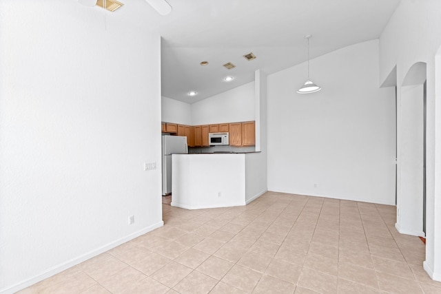 unfurnished living room featuring light tile patterned flooring and high vaulted ceiling