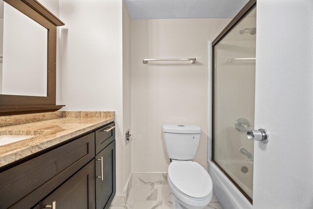 full bathroom featuring bath / shower combo with glass door, toilet, and vanity