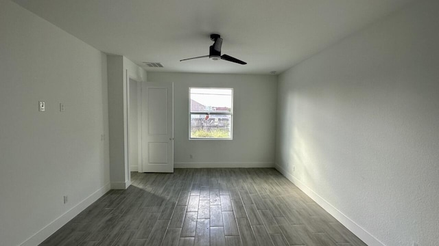 empty room featuring ceiling fan and dark hardwood / wood-style flooring