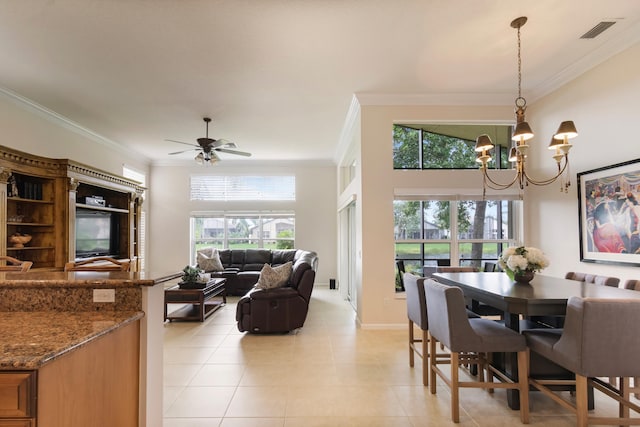 tiled dining area with ceiling fan with notable chandelier and ornamental molding