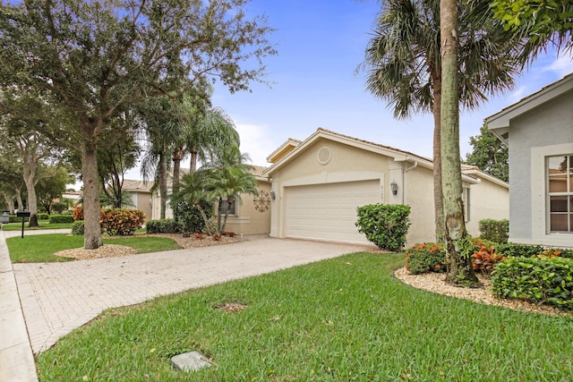 ranch-style house featuring a front lawn and a garage