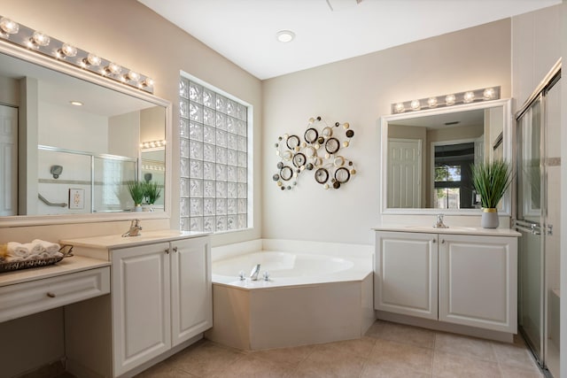 bathroom with tile patterned flooring, shower with separate bathtub, and vanity