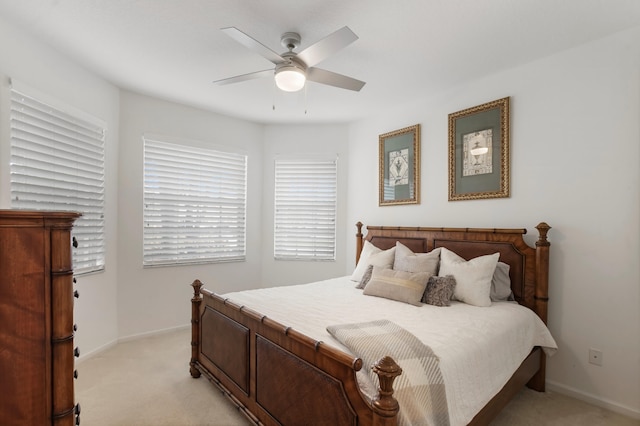 bedroom with light carpet and ceiling fan